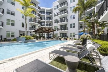 Infinity edge swimming pool with cabanas